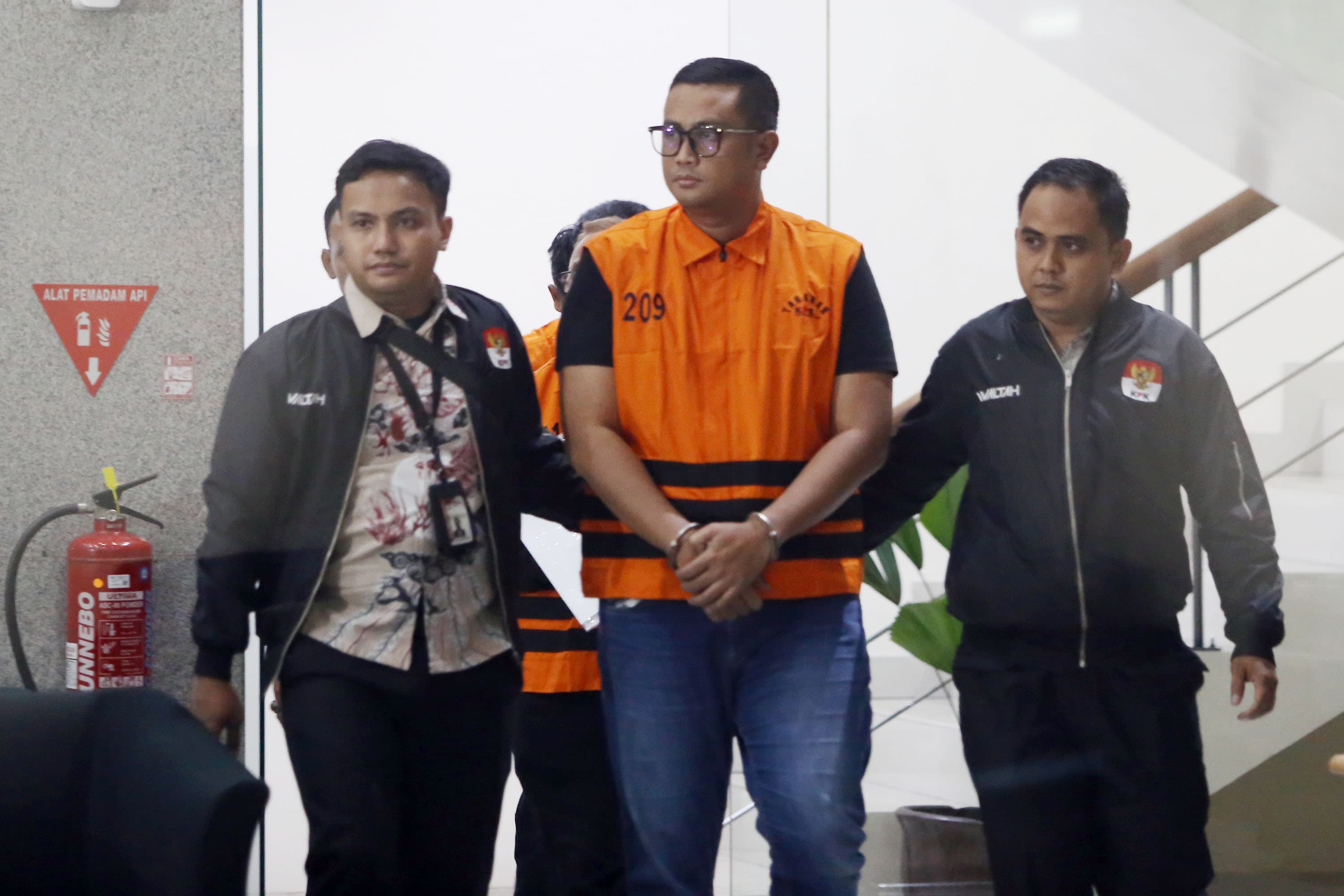 Bupati Klaten Hamenang Wajar Ismoyo Tersangka kasus suap berjalan menuju mobil tahanan usai menjalani pemeriksaaan setelah dilakukan OTT di Gedung Merah Putih KPK, Jakarta, Jum'at (16/10/2026). AKURAT.CO/Sopian 