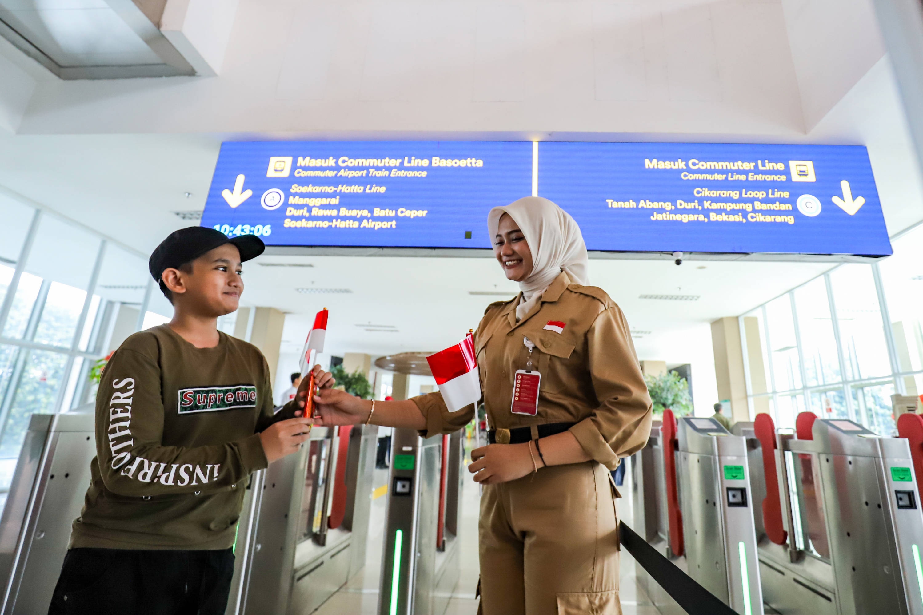 Semarakkan HUT RI, Petugas Kereta Commuter Bagikan Bendera Merah Putih